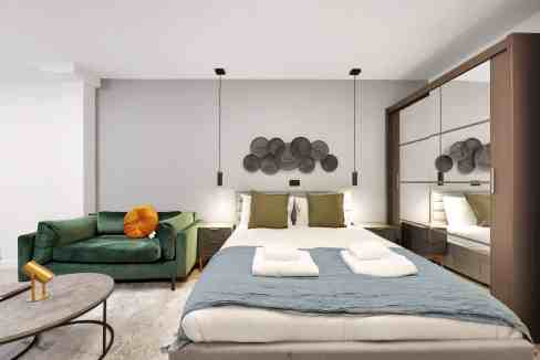 Elegant bedroom featuring a large bed, decorative wall art, and contemporary furniture.