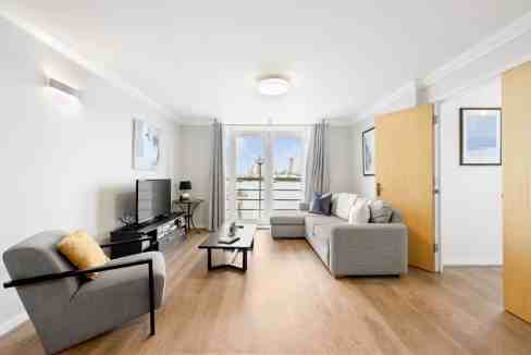 Modern living room with balcony view in Canary Wharf Millennium Wharf.