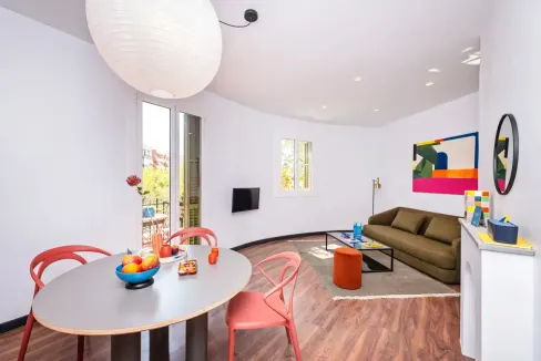 Bright and spacious living room at Joan Miro Park Apartments with contemporary decor and colorful ar.