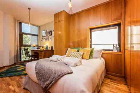 Cozy bedroom in Vila Olimpica Poblenou Apartments with modern decor and natural light.