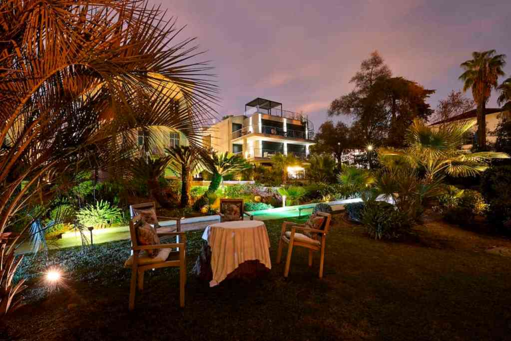 Elegant outdoor garden scene at Cannes Villa Alexandra during evening hours.