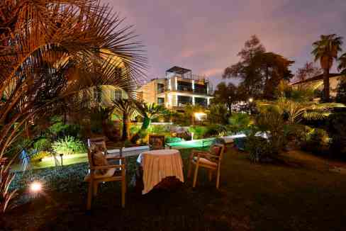 Elegant outdoor garden scene at Cannes Villa Alexandra during evening hours.