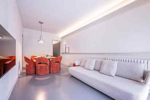 Modern living room at Gaudi Avenue Apartments with sleek furniture and stylish lighting.