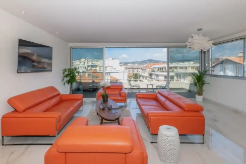Bright, stylish interior with comfortable seating and scenic views of Juan-les-Pins.