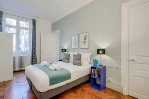 Bright bedroom in Avenue de Messine Apartments with modern decor and natural light.