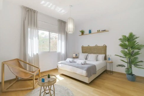 Bright and airy bedroom in Barcelona Monumental Apartments with minimalist decor and natural light.