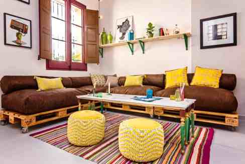 Bright living room with colorful decor and pallet furniture.