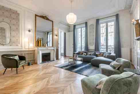 Luxurious living room with vintage furniture, ornate details, and natural light.