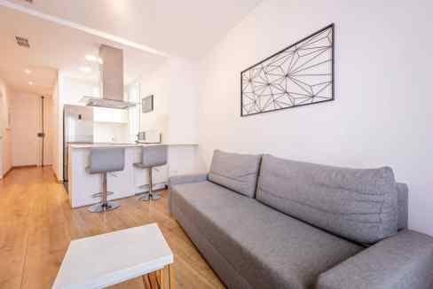Modern Barcelona Urgell Apartments living room with minimalist decor and natural light.