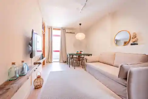 Modern living room with sofa and decor in Wellington Apartments, Carrer de Wellington.
