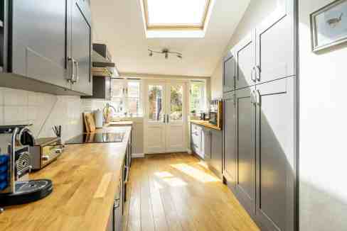 Bright, airy kitchen with skylight and contemporary cabinetry at Darnborough Street Apartments.