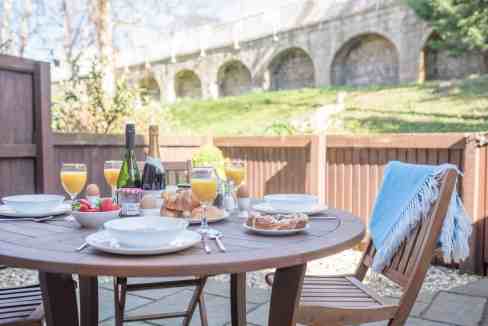 Outdoor dining table with breakfast and drinks at York Pear Tree House.