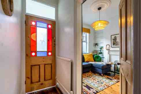 Cozy living room with colorful cushions and vintage decor in a charming home.