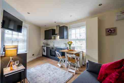 Modern kitchen and living space at Fishergate Apartments with natural light and contemporary furnish.