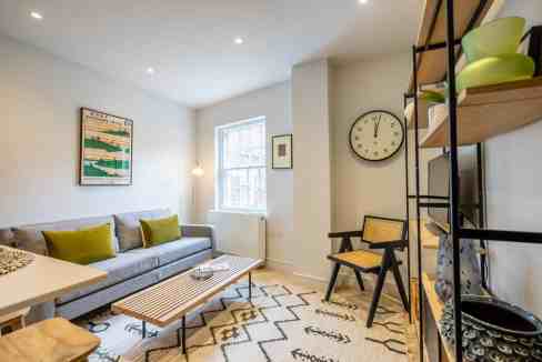Bright living room with modern decor at Swinegate Apartments. Featuring a comfortable sofa, stylish.