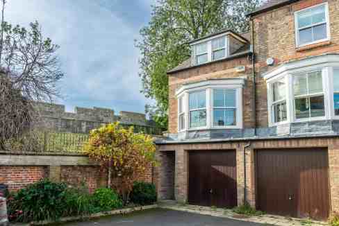 Spacious apartment building with brick facade and large bay windows in Dewsbury.