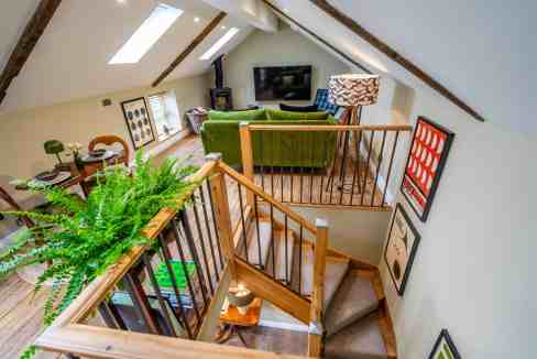 Bright attic living space with modern furniture and artwork.