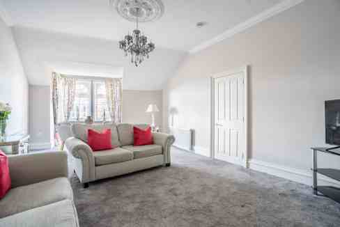 Spacious living room at Clifford St Apartments with elegant decor and natural light.