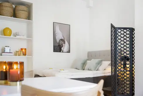 Modern bedroom with cozy bed and stylish decor at Stockholm Observatory Apartments.
