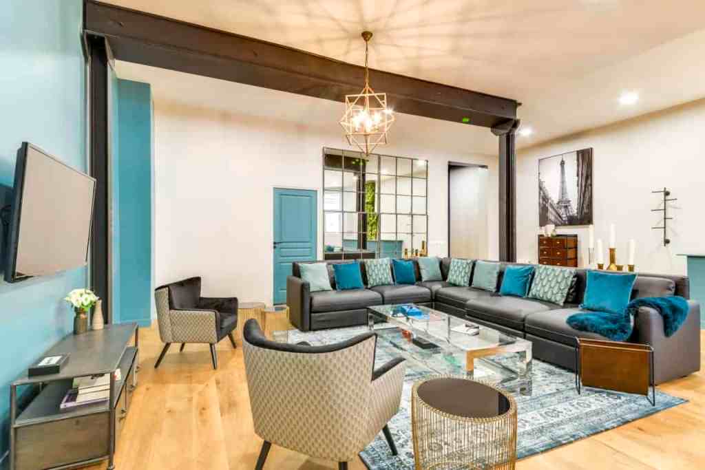 Contemporary living room with a large sectional sofa, armchairs, and modern decor.