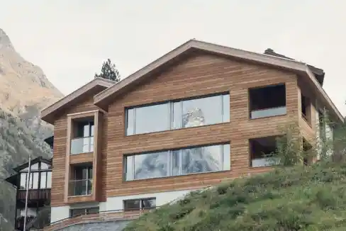 Contemporary wooden lodge overlooking mountain landscape at Riedweg Overlook.