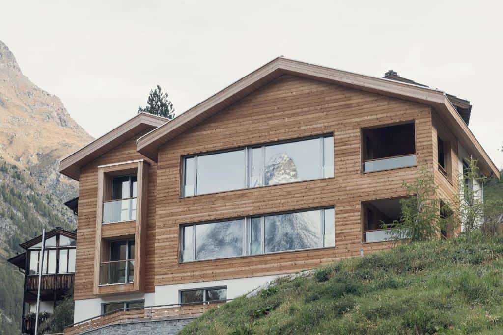 Contemporary wooden lodge overlooking mountain landscape at Riedweg Overlook.