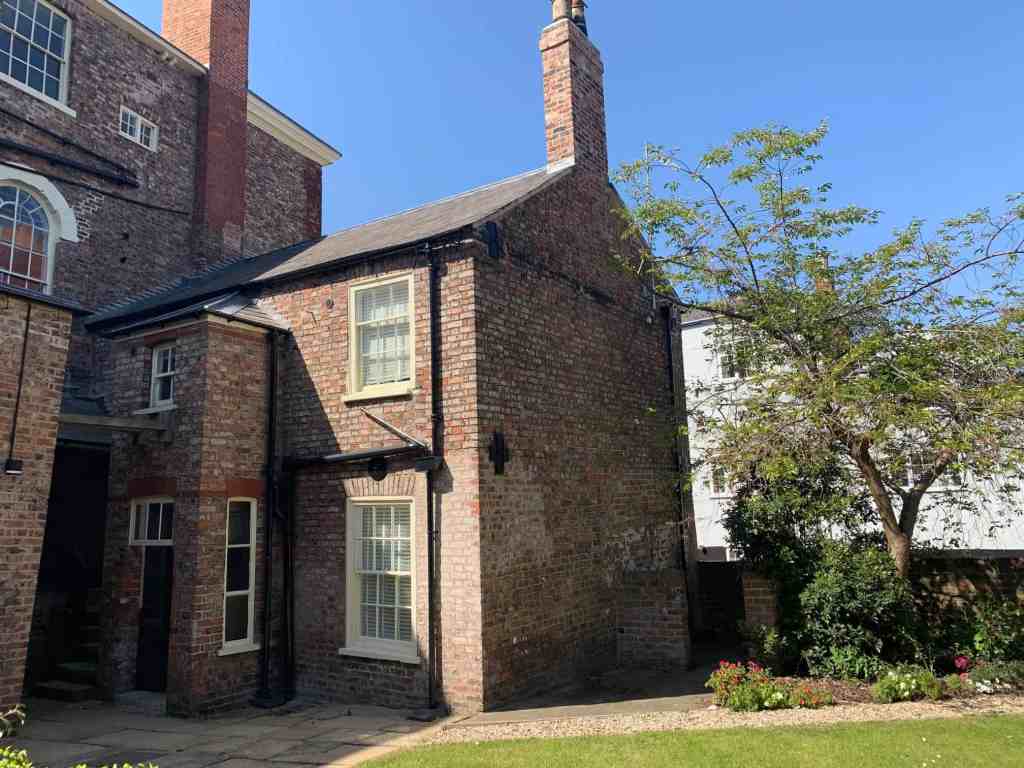 Charming brick cottage with garden and mature trees in Walmgate area.