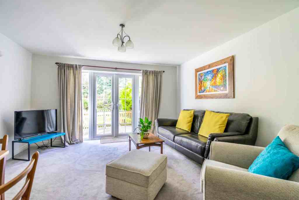Bright living room with large windows and modern furnishings.