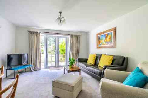 Bright living room with large windows and modern furnishings.