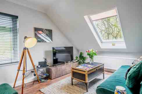 Cozy loft living space with natural light and modern decor.