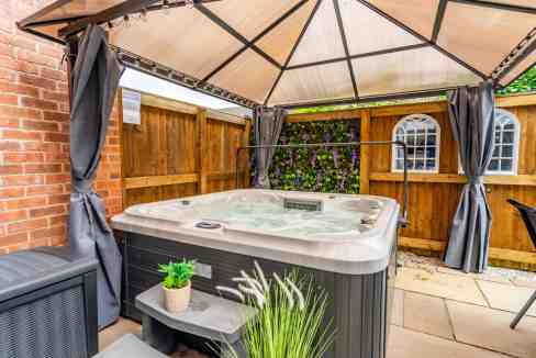 Hot tub with canopy in outdoor garden setting at The Ebor House.