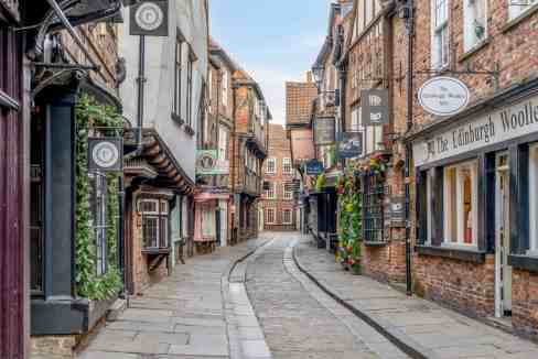 Historic Shambles street with charming shops and cafes in York, UK.
