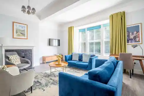 Cozy living room at Toft Green Apartments with bright natural light, modern furniture, and stylish d.