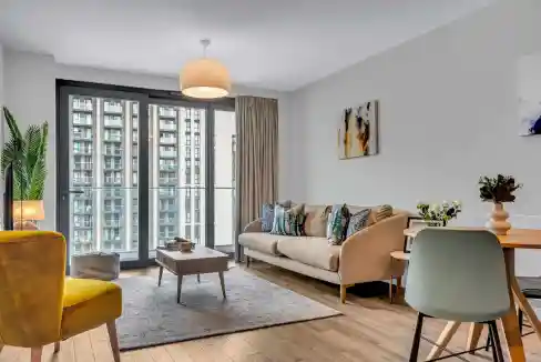 Bright living room with large windows, contemporary furniture, and colorful accents.