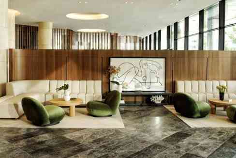 Elegant hotel lobby featuring plush seating and artistic wall art in Canberra City Hill.