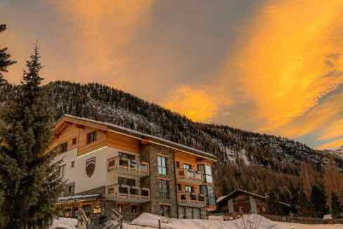 Alpine ski lodge in Zermatt with mountain views and snowy landscape.