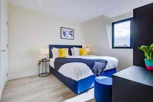 Modern bedroom at Sutton Nonsuch Park Apartments with stylish decor and natural light.