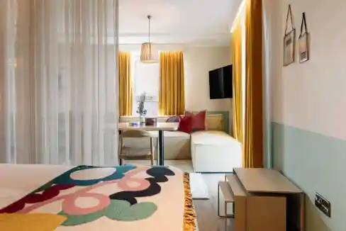 Bright, modern Belfast City Centre Aparthotel room with comfortable seating and stylish decor.