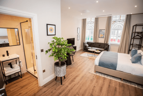 Apt hotel room at The Gresham Aparthotel with contemporary furnishings and large windows.