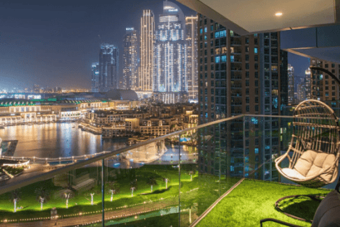 Modern Dubai downtown apartment balcony with city skyline view at night.