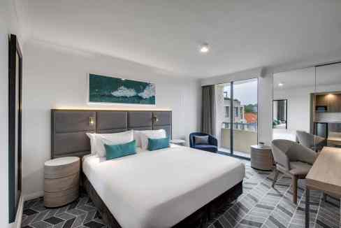 A modern hotel room at Coogee Beach Aparthotel with stylish decor and ocean views.