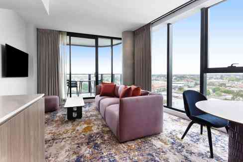 Luxurious apartment interior at Coburg Pentridge Aparthotel with large windows and contemporary furn.
