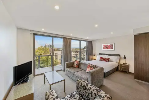 Modern apartment with a large window view in Canberra Dickson Aparthotel.