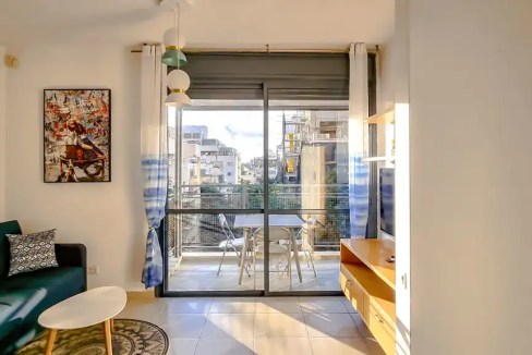 Bright living room with balcony in Tel Aviv Dizengoff Apartments.