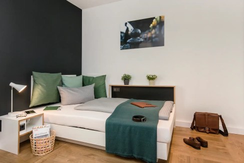 Comfortable bedroom with stylish decor at Berlin Velodrom Apartments. Perfect for a relaxing stay in.