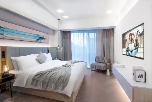 Modern hotel room in Shanghai People's Park Aparthotel with contemporary design and large window vie.