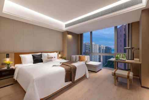 Aparthotel room at Shenzhen Houhai with large window view of the city skyline.