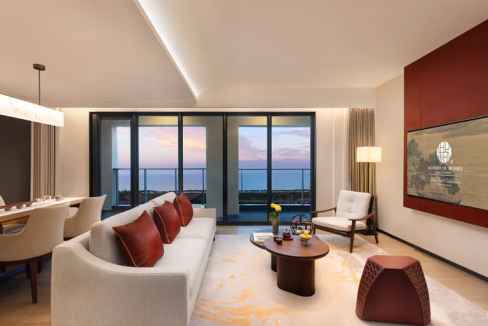 Elegant living room with ocean views and modern decor at Haikou Aparthotel. Perfect for relaxing and.