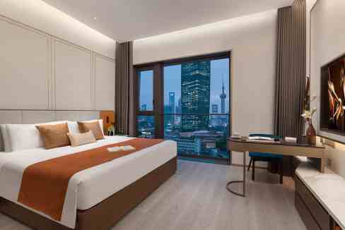 Aptly furnished hotel room at Shanghai North Bund Aparthotel with panoramic city views and contempor.