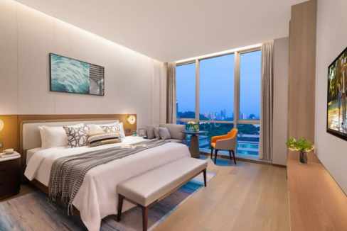 Spacious Shenzhen Qiaoxiang Road Aparthotel room with large windows and modern furnishings.